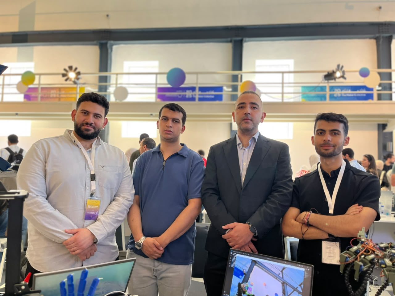 MCC team members with a prosthetic hand demo at a robotics event