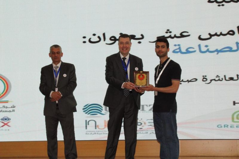 MCC founder receiving a recognition plaque on stage at an industry event